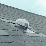 Puits de lumière solaire installé sur une toiture en ardoise. Solution d'éclairage naturel.